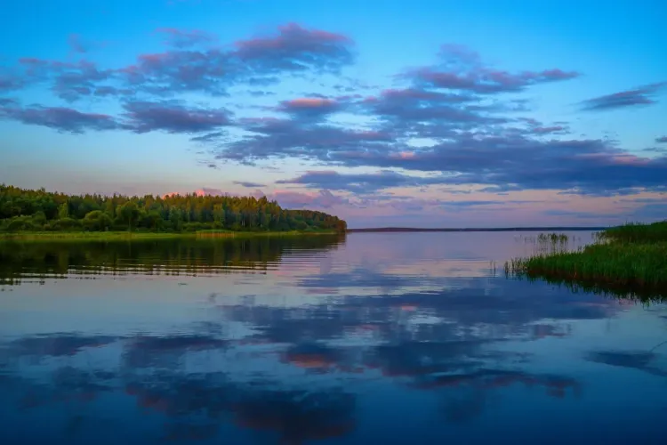 Закат над озером с лесистыми островами и зеркальной водой для атмосферы Браславских озёр.